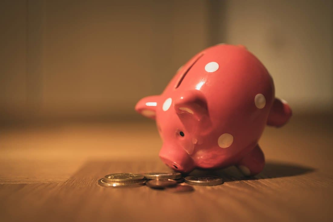 A red piggy bank with coins
